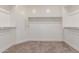 Walk-in closet features carpet flooring and built-in shelving and racks at 716 W Blue Ridge Dr, San Tan Valley, AZ 85140