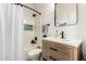 Well-lit bathroom with white shower curtain, dark hardware, modern wood vanity and decorative mosaic backsplash at 7445 E Eagle Crest Dr # 1145, Mesa, AZ 85207