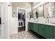 Bright bathroom featuring double vanity, mirrors, patterned tile floors, and access to a walk in closet at 7445 E Eagle Crest Dr # 1145, Mesa, AZ 85207