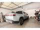 Spacious garage featuring an electric car, ample storage, and an automatic door at 7445 E Eagle Crest Dr # 1145, Mesa, AZ 85207