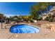 Community hot tub with stone accents, patio seating, and mature landscaping at 7445 E Eagle Crest Dr # 1145, Mesa, AZ 85207