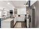 Stylish kitchen featuring stainless appliances, a breakfast bar, white cabinets, and decorative tile backsplash at 7445 E Eagle Crest Dr # 1145, Mesa, AZ 85207