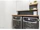 Functional laundry room with front loading washer and dryer, wood countertop, cabinets and decor shelves at 7445 E Eagle Crest Dr # 1145, Mesa, AZ 85207