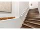 Elegant staircase with stained wood steps, white risers, handrail, and decorative niche at 7445 E Eagle Crest Dr # 1145, Mesa, AZ 85207