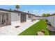 Nicely landscaped backyard with artificial grass, awning, and stylish tiled patio, great for outdoor enjoyment at 7643 E Rancho Vista Dr, Scottsdale, AZ 85251