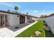 Well-maintained backyard with artificial grass, awning, and stylish tiled patio, ideal for entertaining at 7643 E Rancho Vista Dr, Scottsdale, AZ 85251