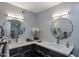 Bathroom featuring dual sinks with bright lighting and granite countertops at 7643 E Rancho Vista Dr, Scottsdale, AZ 85251