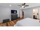 Spacious bedroom with TV, wood floors, and an en-suite bathroom at 7643 E Rancho Vista Dr, Scottsdale, AZ 85251