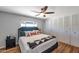 Comfortable bedroom featuring a ceiling fan, wood floors, and closet with louvered doors at 7643 E Rancho Vista Dr, Scottsdale, AZ 85251