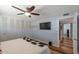 Bedroom boasting wood floors, TV, ceiling fan, and closet with louvered doors at 7643 E Rancho Vista Dr, Scottsdale, AZ 85251