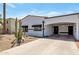 Well-kept single-story home featuring a covered carport and desert landscaping with Saguaro cactus at 7643 E Rancho Vista Dr, Scottsdale, AZ 85251