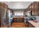 Spacious kitchen with stainless steel refrigerator, modern appliances, and wood floors at 7643 E Rancho Vista Dr, Scottsdale, AZ 85251