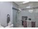 Modern tiled shower with glass door and decorative accents at 7643 E Rancho Vista Dr, Scottsdale, AZ 85251