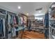 Walk-in closet with built-in shelving and clothes racks at 7643 E Rancho Vista Dr, Scottsdale, AZ 85251