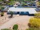 Aerial shot showcasing unique desert landscaping, main home, and convenient street access at 7667 E Cactus Rd, Scottsdale, AZ 85260