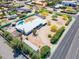 Aerial view of property boundaries and a unique single Gathering house with pool in a desert-landscaped neighborhood at 7667 E Cactus Rd, Scottsdale, AZ 85260