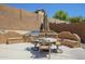 Inviting outdoor dining area featuring a built-in grill, table, and seating under the sunny sky at 768 E Mountain Sky Ave, Phoenix, AZ 85048