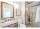Bathroom features a glass shower, a framed mirror, and a single sink vanity at 768 E Mountain Sky Ave, Phoenix, AZ 85048
