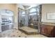 Elegant bathroom featuring glass shower, stone details, and access to the primary bedroom at 768 E Mountain Sky Ave, Phoenix, AZ 85048