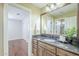 Bathroom showcases a stone countertop, a mirror, and a doorway leading to a bedroom at 768 E Mountain Sky Ave, Phoenix, AZ 85048