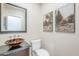 Stylish powder room featuring a unique vessel sink, granite countertop, and decorative artwork at 768 E Mountain Sky Ave, Phoenix, AZ 85048