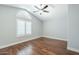 Bedroom has a vaulted ceiling, wood floor, ceiling fan, and a window with plantation shutters at 768 E Mountain Sky Ave, Phoenix, AZ 85048
