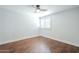Bright bedroom showing hardwood floors, a ceiling fan, and a window with shutter at 768 E Mountain Sky Ave, Phoenix, AZ 85048