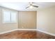 Bedroom showcasing hardwood floors, a ceiling fan, and a window with white shutters at 768 E Mountain Sky Ave, Phoenix, AZ 85048