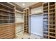 Walk-in closet with custom wood organizers, shelving, drawers, and tile floors at 768 E Mountain Sky Ave, Phoenix, AZ 85048