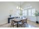 Dining room with modern chandelier, accent wall, and large windows at 768 E Mountain Sky Ave, Phoenix, AZ 85048