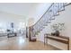 Elegant foyer with staircase, iron railing, and decorative console table at 768 E Mountain Sky Ave, Phoenix, AZ 85048