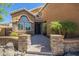 Inviting front entrance with stone accents and desert landscaping that creates a warm curb appeal at 768 E Mountain Sky Ave, Phoenix, AZ 85048