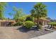 Charming exterior view showcasing the home with lush landscaping, mature trees, and a private gate at 768 E Mountain Sky Ave, Phoenix, AZ 85048