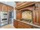 Gourmet kitchen with stainless steel appliances, custom cabinetry, and a stylish tile backsplash at 768 E Mountain Sky Ave, Phoenix, AZ 85048