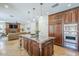 Open kitchen with a granite island, custom cabinets, and stainless steel appliances at 768 E Mountain Sky Ave, Phoenix, AZ 85048