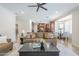 Bright living room featuring a stylish ceiling fan and an open-concept design connecting to the kitchen at 768 E Mountain Sky Ave, Phoenix, AZ 85048