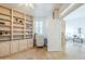 Bright home office boasts custom built-ins, desk area, and serene views into the living room at 768 E Mountain Sky Ave, Phoenix, AZ 85048