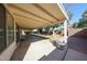 View of the back patio, featuring a concrete floor and stone bench seating overlooking the yard at 8017 W Eugie Ave, Peoria, AZ 85381