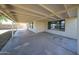 This is a view of the covered back patio, which features a concrete floor and access to the backyard at 8017 W Eugie Ave, Peoria, AZ 85381