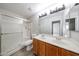 Bathroom featuring a double vanity and glass-enclosed shower at 8017 W Eugie Ave, Peoria, AZ 85381