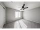 Bedroom featuring a ceiling fan and large window at 8017 W Eugie Ave, Peoria, AZ 85381