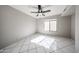Spacious bedroom with tile floors, ceiling fan and lots of natural light at 8017 W Eugie Ave, Peoria, AZ 85381