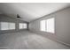 A bright bedroom features two windows and a ceiling fan at 8017 W Eugie Ave, Peoria, AZ 85381