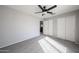A bright bedroom with a ceiling fan and closet at 8017 W Eugie Ave, Peoria, AZ 85381