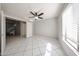 Bright bedroom with tile floors, ceiling fan and direct access to a hallway at 8017 W Eugie Ave, Peoria, AZ 85381