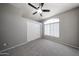 Bedroom featuring a ceiling fan, window, and closet with sliding doors at 8017 W Eugie Ave, Peoria, AZ 85381