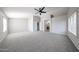Bright bedroom featuring neutral carpet, a ceiling fan, and two windows for natural light at 8017 W Eugie Ave, Peoria, AZ 85381