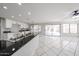 Bright open-concept kitchen features black countertops, and white cabinetry at 8017 W Eugie Ave, Peoria, AZ 85381