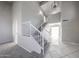Bright living room featuring neutral decor, a staircase, and sleek tiled floors leading to the entrance at 8017 W Eugie Ave, Peoria, AZ 85381