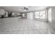 Bright open-concept living room features tile flooring, leading to a kitchen area at 8017 W Eugie Ave, Peoria, AZ 85381